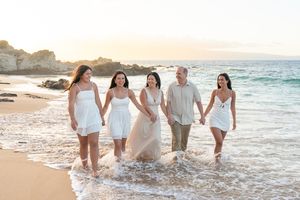 Maui family photographer photo against beautiful Maui beach cliff by ohwowfotos.