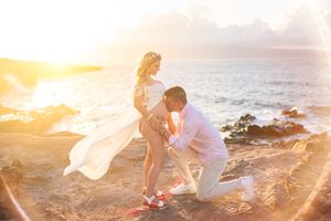 Maui maternity photographer photo against beautiful Maui beach cliff by ohwowfotos.