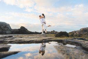 Maui couple proposal engagement photographer photo against beautiful Maui beach cliff sunset by ohwowfotos.