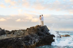 Maui couple proposal engagement photographer photo against beautiful Maui beach cliff sunset by ohwowfotos.