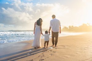 Maui family photographer photo against beautiful Maui beach cliff sunrise by ohwowfotos.