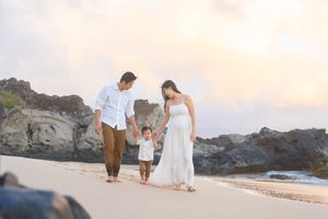 Maui family photographer photo against beautiful Maui beach cliff sunrise by ohwowfotos.