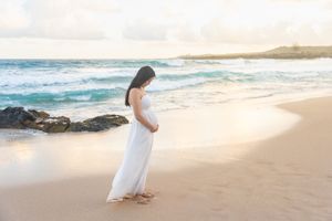 Maui family photographer photo against beautiful Maui beach cliff sunrise by ohwowfotos.