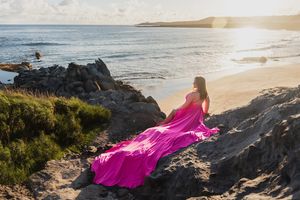 Maui flying dress photographer photo against beautiful Maui beach cliff by ohwowfotos.