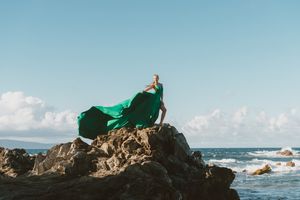 Maui flying dress photographer photo against beautiful Maui beach cliff by ohwowfotos.