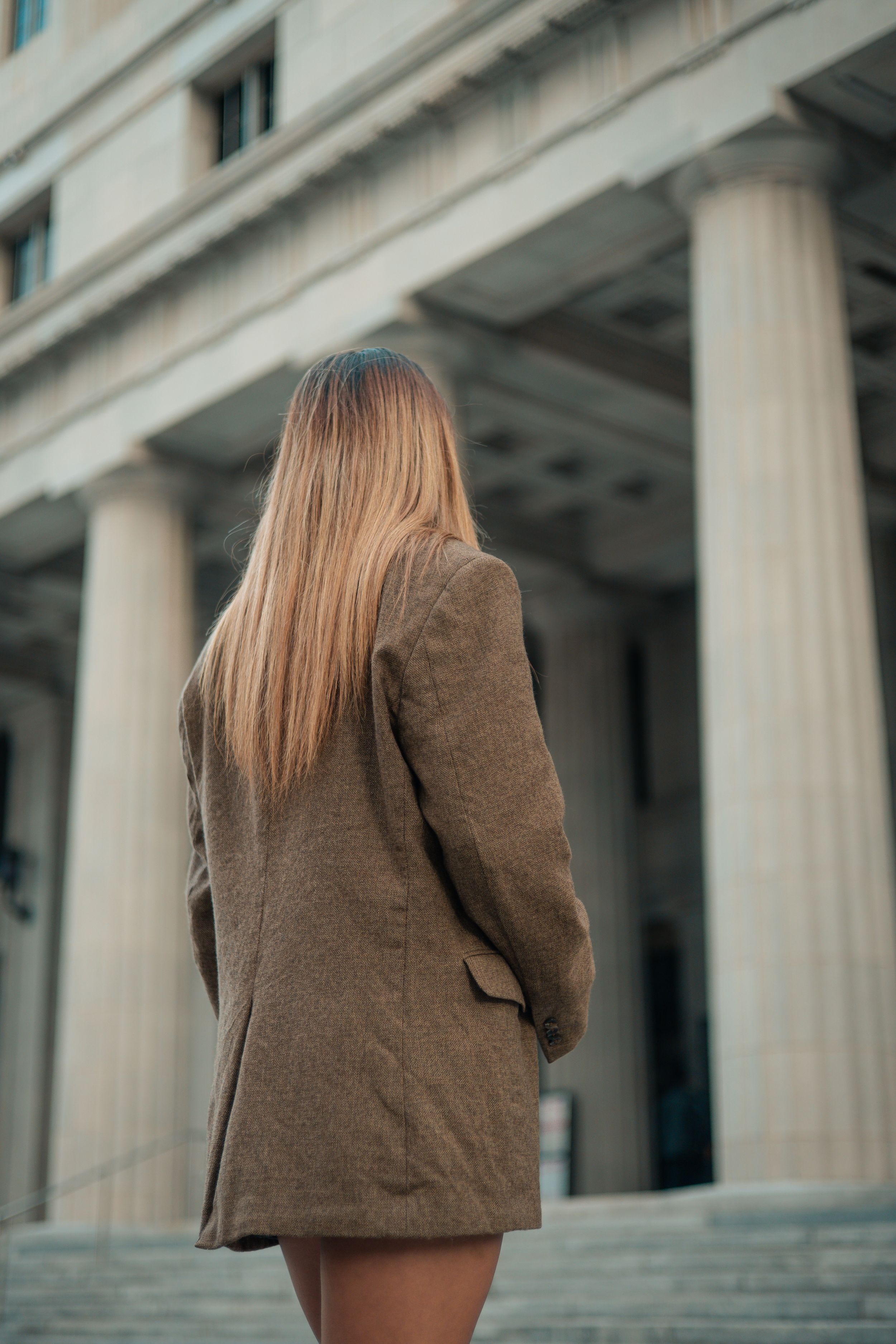 Back view of model walking courthouse steps, Fort Lauderdale editorial fashion shot, cinematic portrait by Mannyportraits.