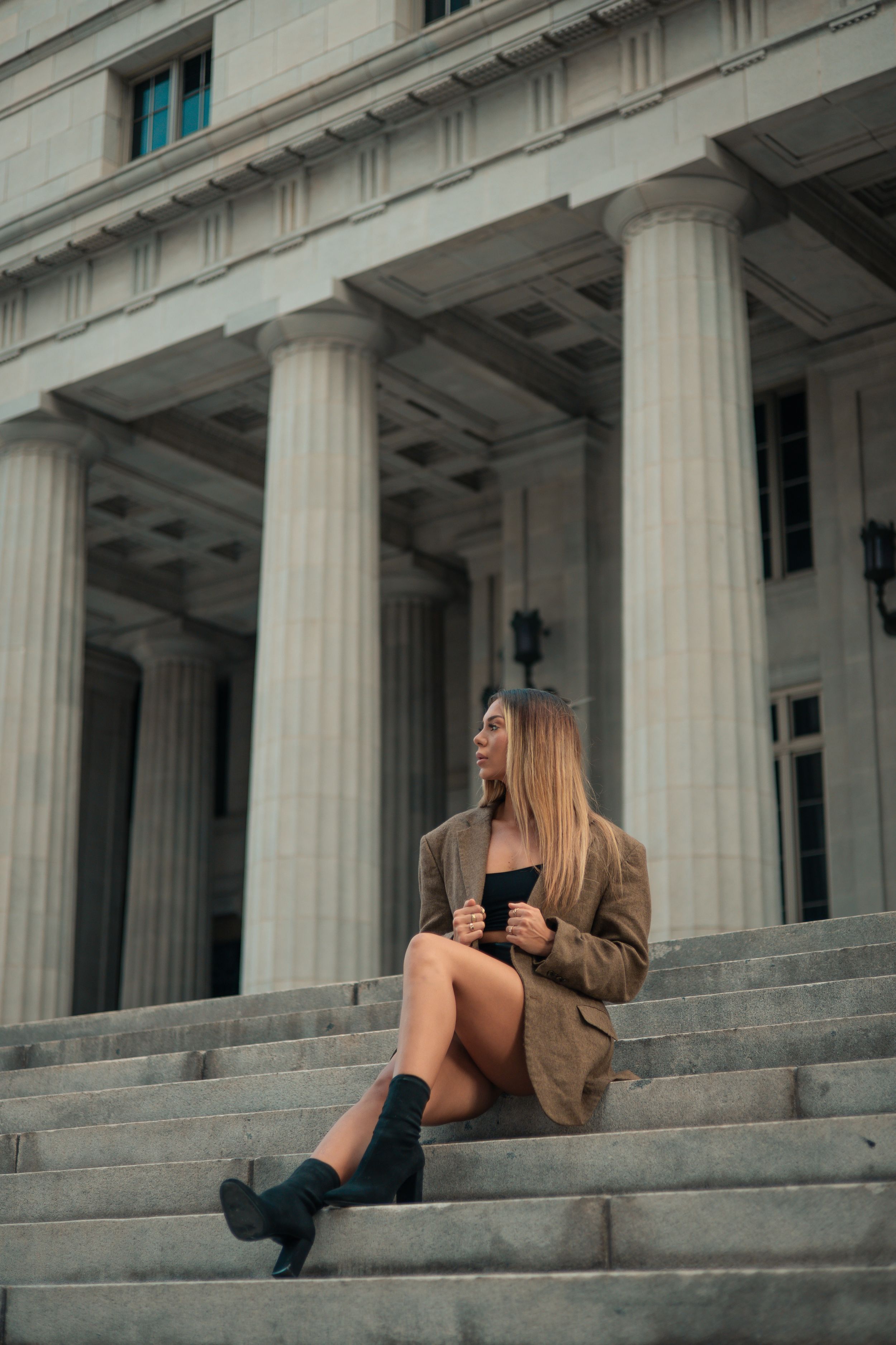 Full-body portrait of woman posing on historic steps in South Florida, Mannyportraits editorial fashion photoshoot with designer-inspired