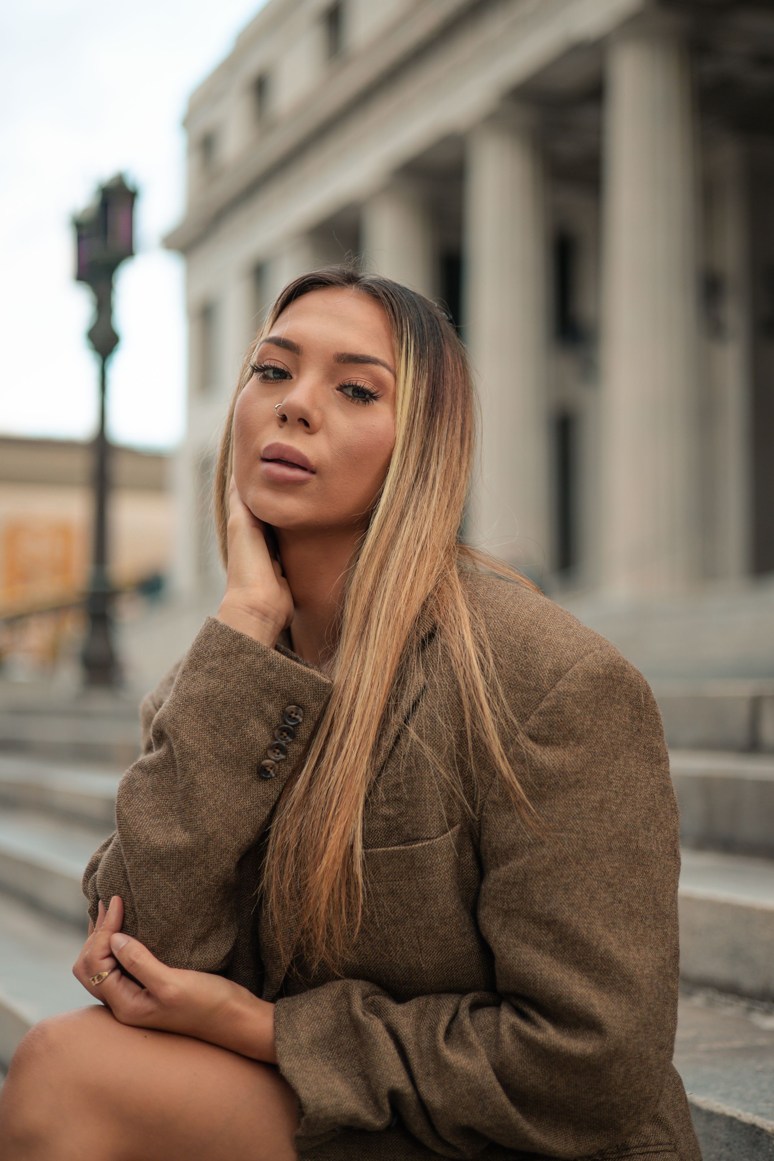 Model seated confidently on tall marble stairs, Fort Lauderdale editorial fashion portrait, cinematic photography by Mannyportraits.