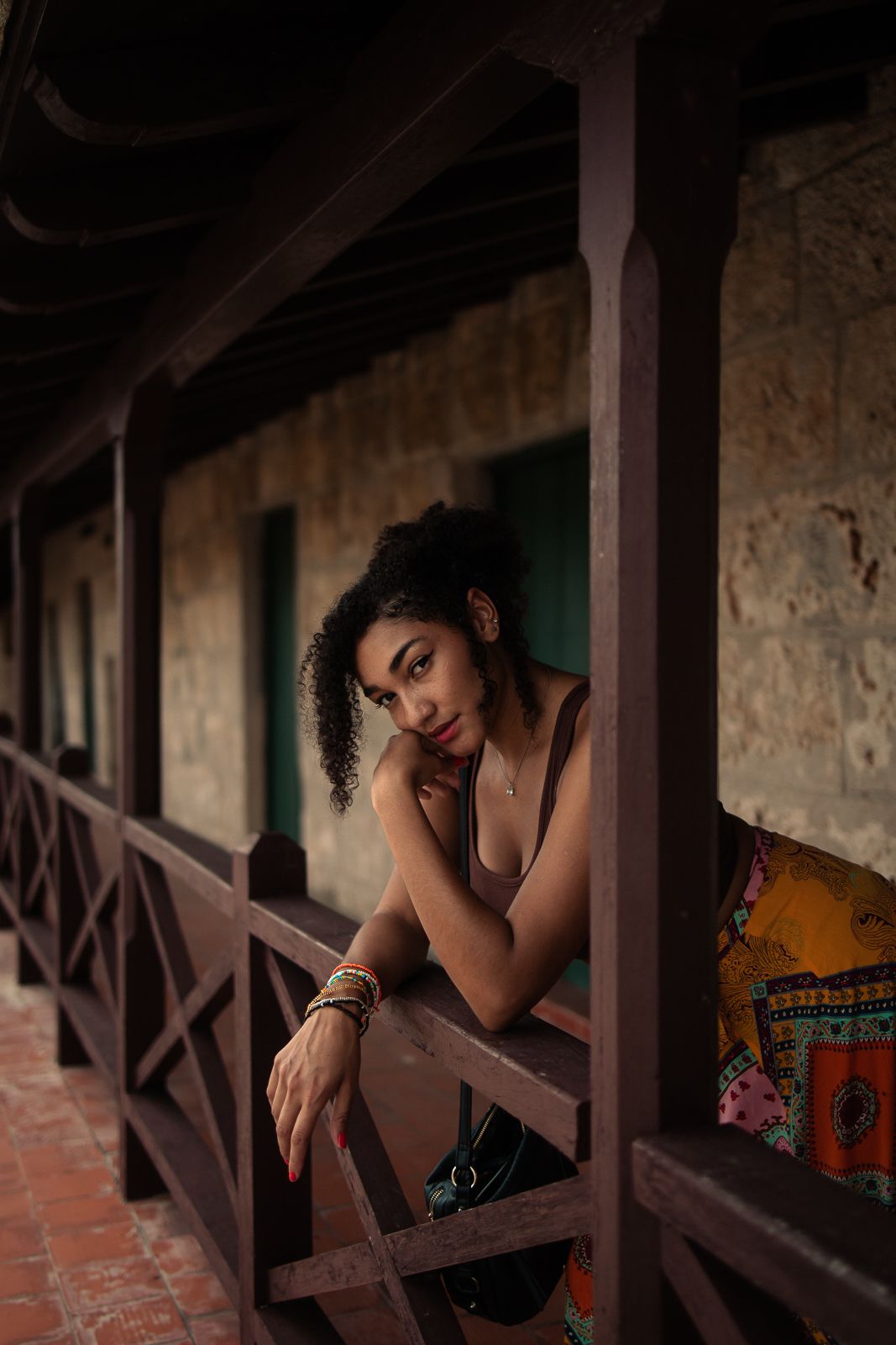 Moody portrait on rustic balcony, South Florida cinematic editorial captured by Mannyportraits for fashion and lifestyle campaigns.