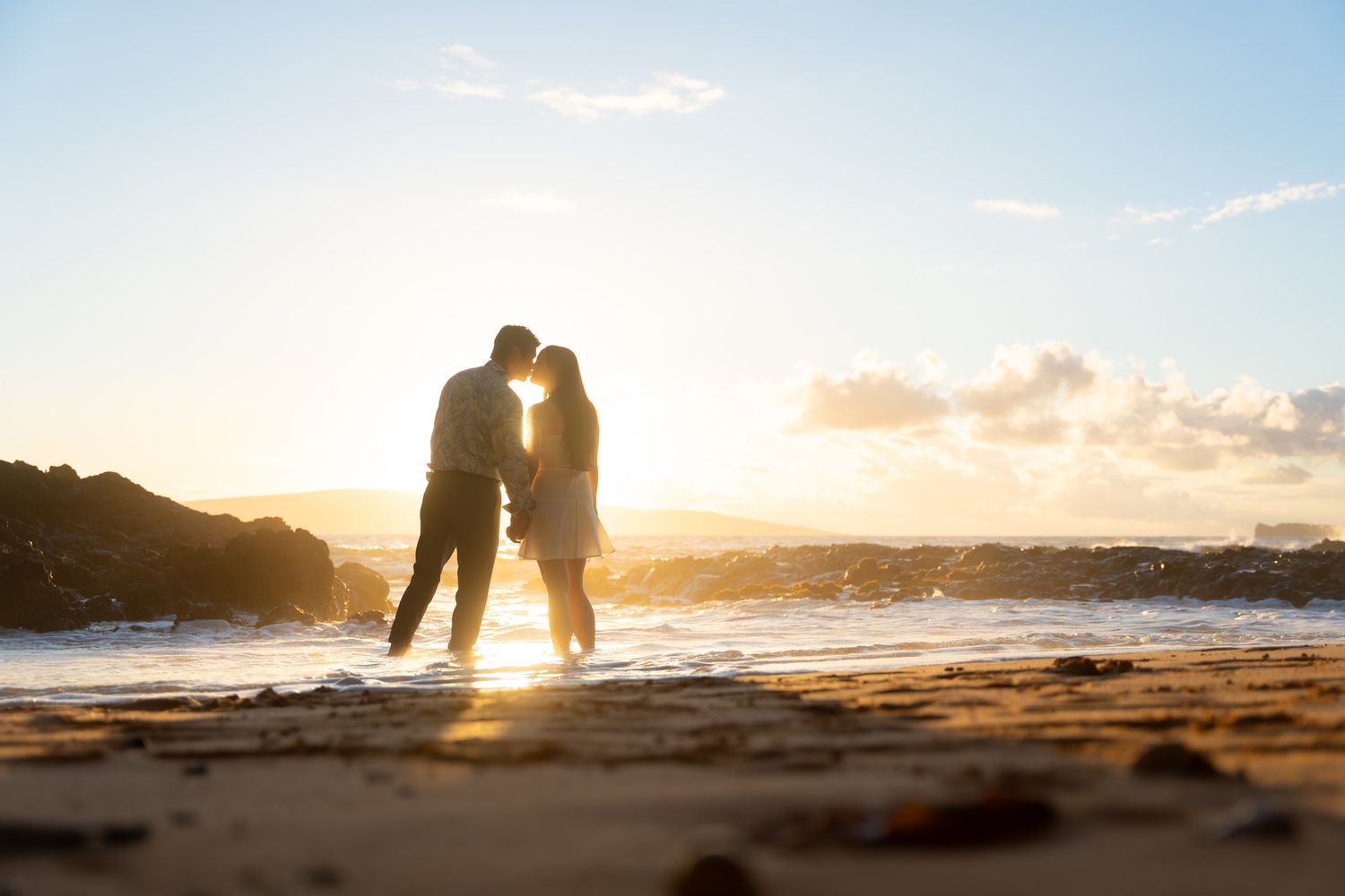 Maui wedding photographer photo against beautiful Maui sunset beach by ohwowfotos.