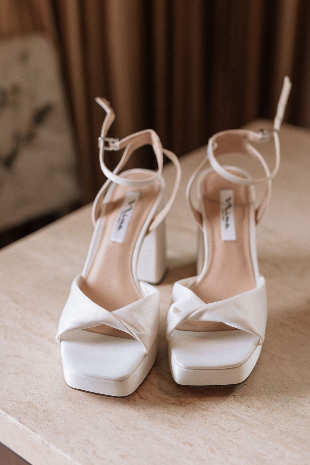 Detailed photo of bridal heels on a table at a Malibu wedding venue.