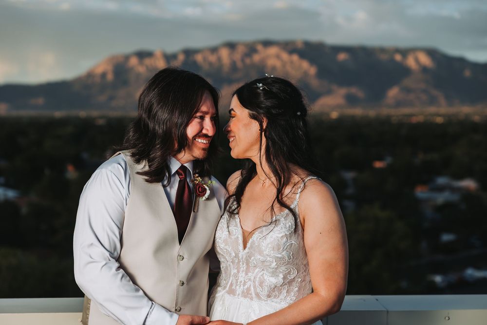 Panoramic mountain wedding series showing couple in elegant attire embracing against dramatic desert landscape at sunset.