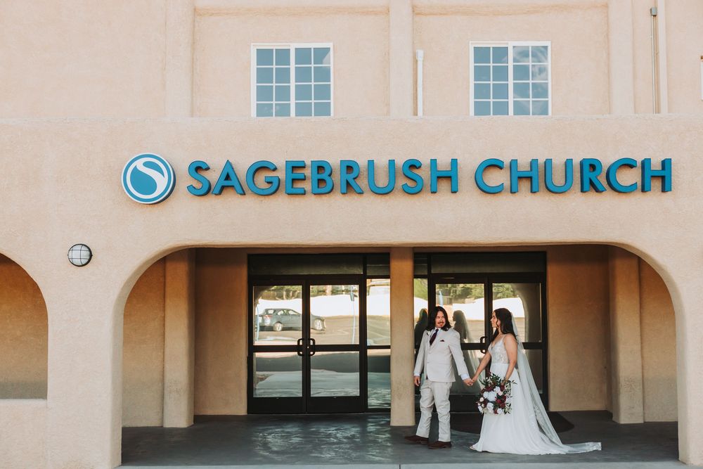 Large tan Sagebrush Church building exterior with modern signage and multiple entrance doors.