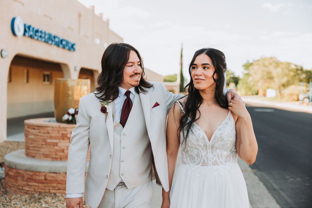 A romantic desert wedding photo collection showing newlyweds walking together and embracing in warm sunset lighting.