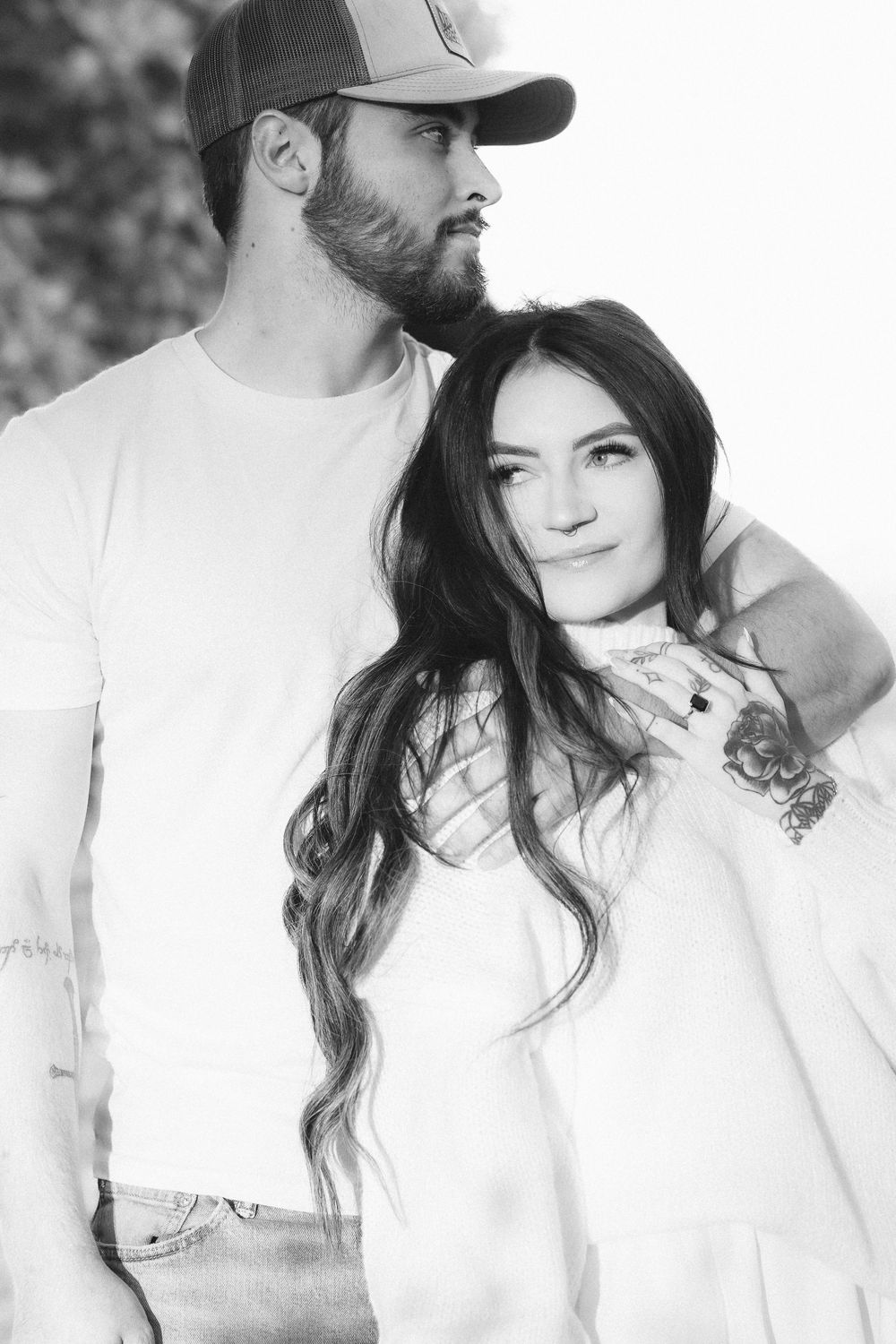A series of intimate black and white close-up portraits showing a couple in white clothing.