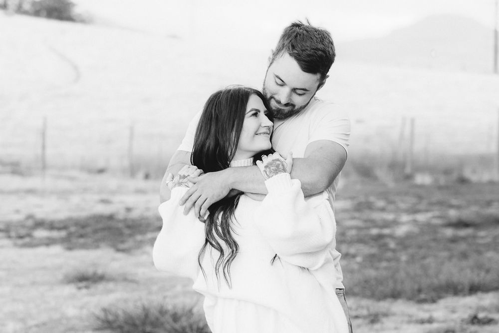 A collection of candid black and white photos showing a couple's tender moments together.