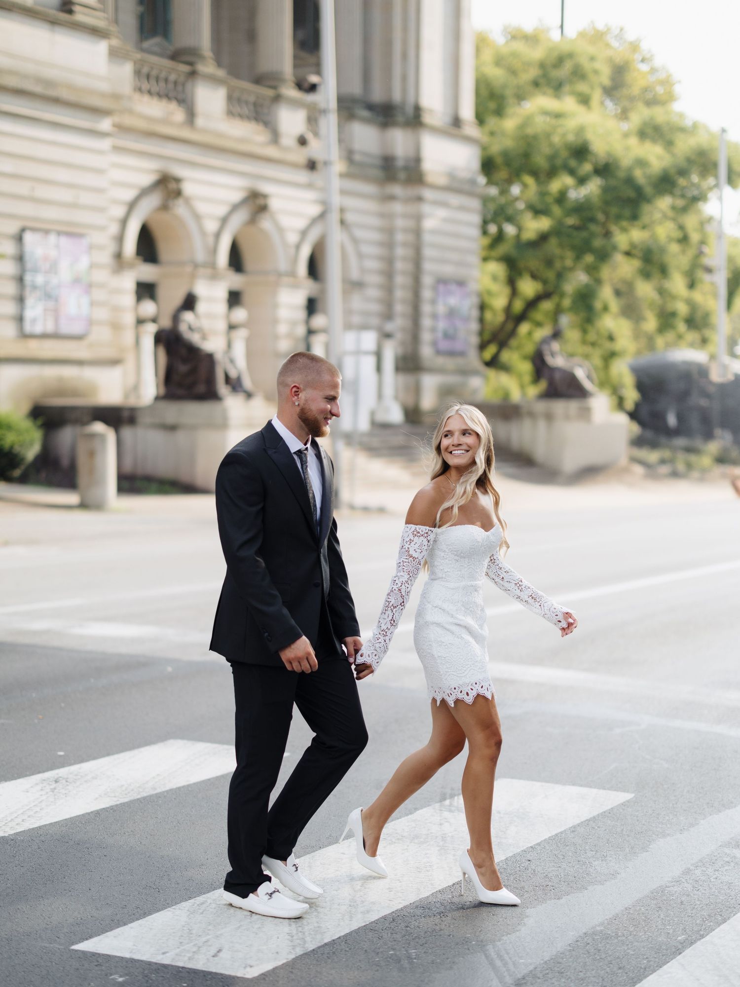 A series of five wedding photos showing a bride and groom walking and laughing together on a paved path.