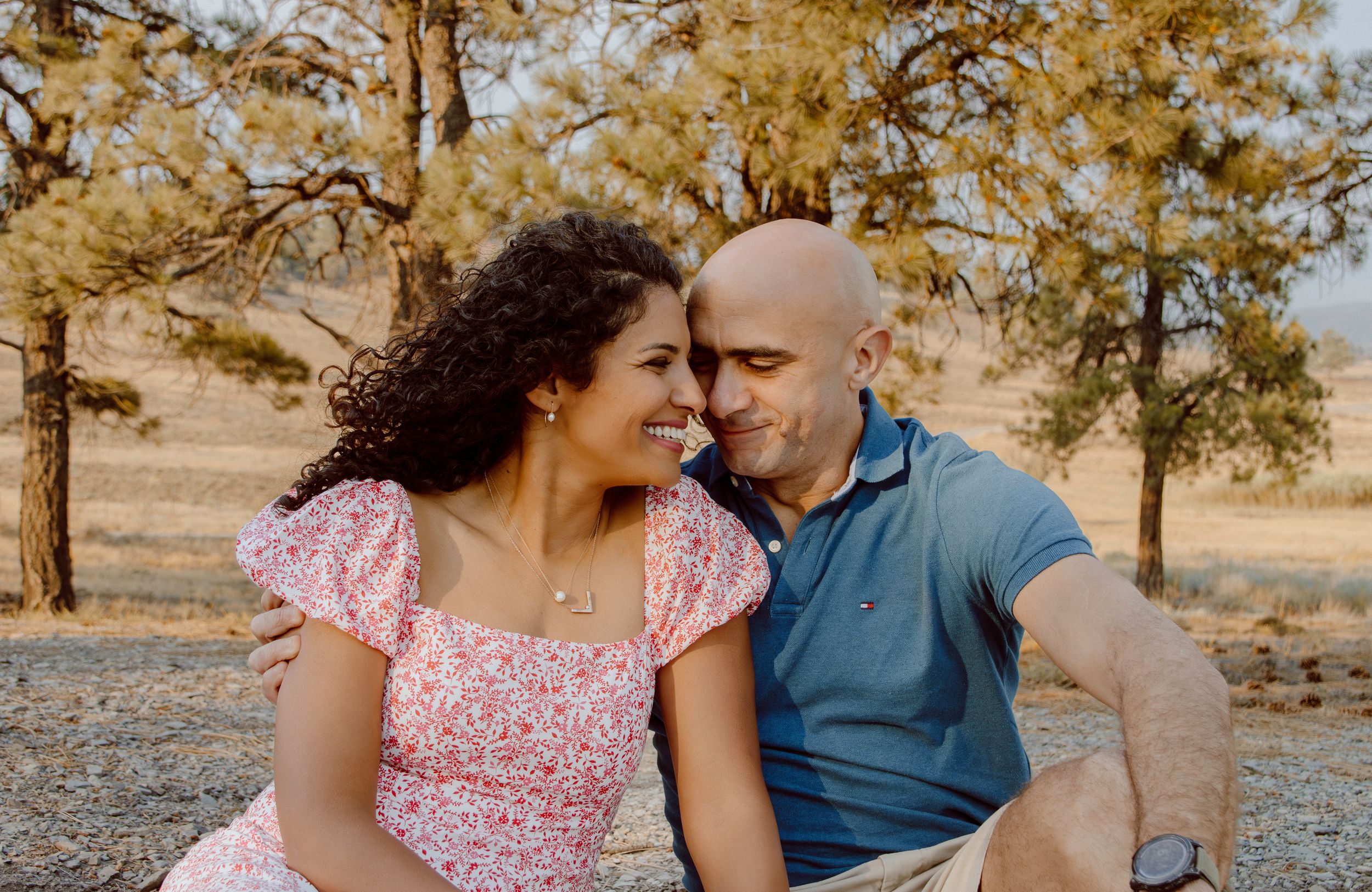 Two people share intimate moments outdoors against a desert backdrop in a series of romantic candid photos.