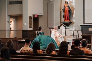 Wedding photo session in a church interior featuring elegant formal attire and decorative elements.