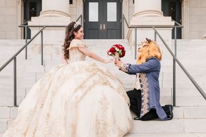 A bride in a champagne-colored ballgown gracefully walks across an elegant marble corridor in soft natural light.