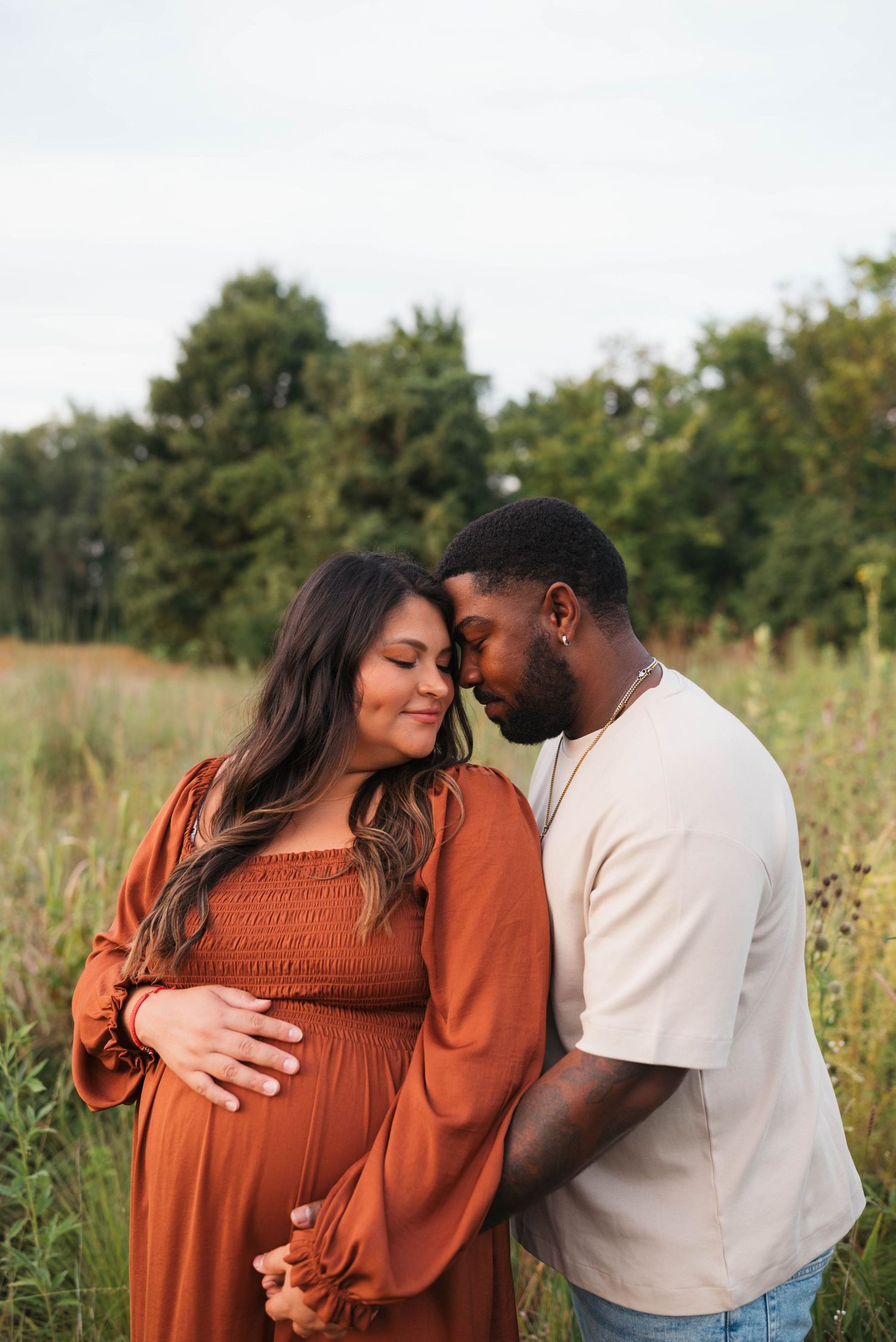Romantic couple sharing tender moments in a sunlit field.