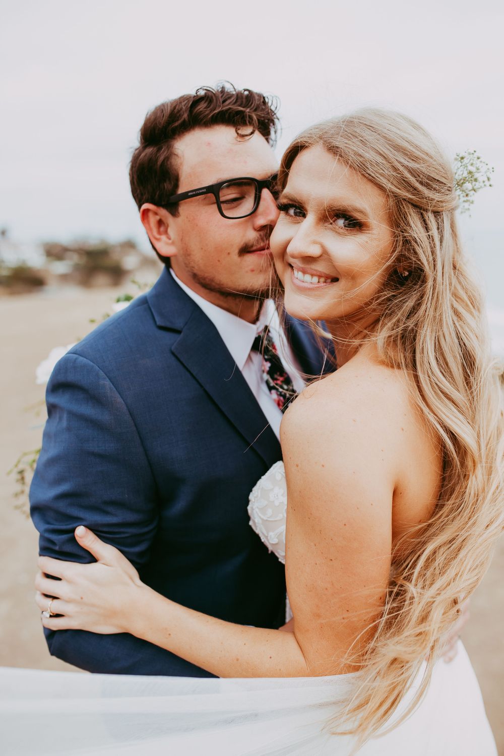 Close-up romantic wedding photography series of couple embracing at sunset outdoors.