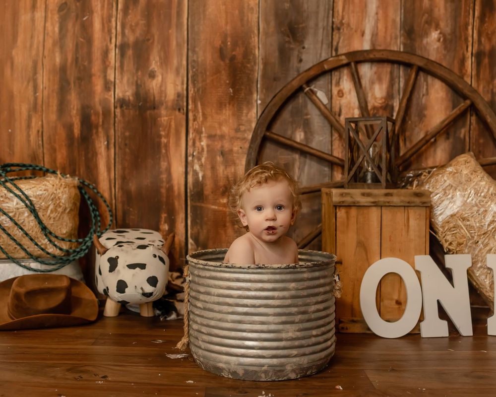 Rustic studio photography setup featuring vintage wooden backdrop and decorative galvanized metal tubs.