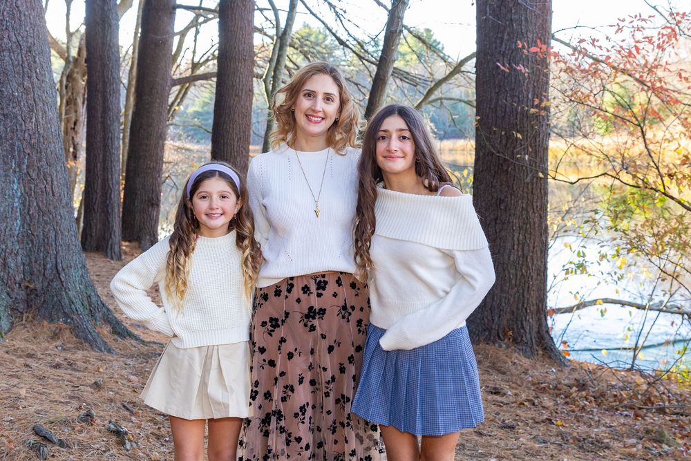 A family poses for a fall portrait with during family photo session at The Wayside Inn Grist Mill in Sudbury, MA with Lisa West Photography.