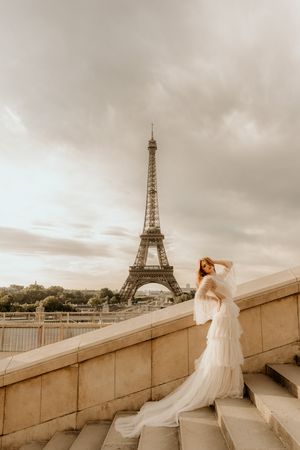 Series of romantic photos at sunrise or sunset featuring white dress against Eiffel Tower backdrop in Paris, France.
