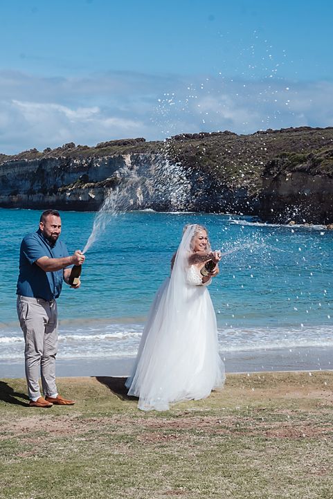Couple in wedding attire pops champagne on a scenic beach, creating a playful sequence of celebratory moments.