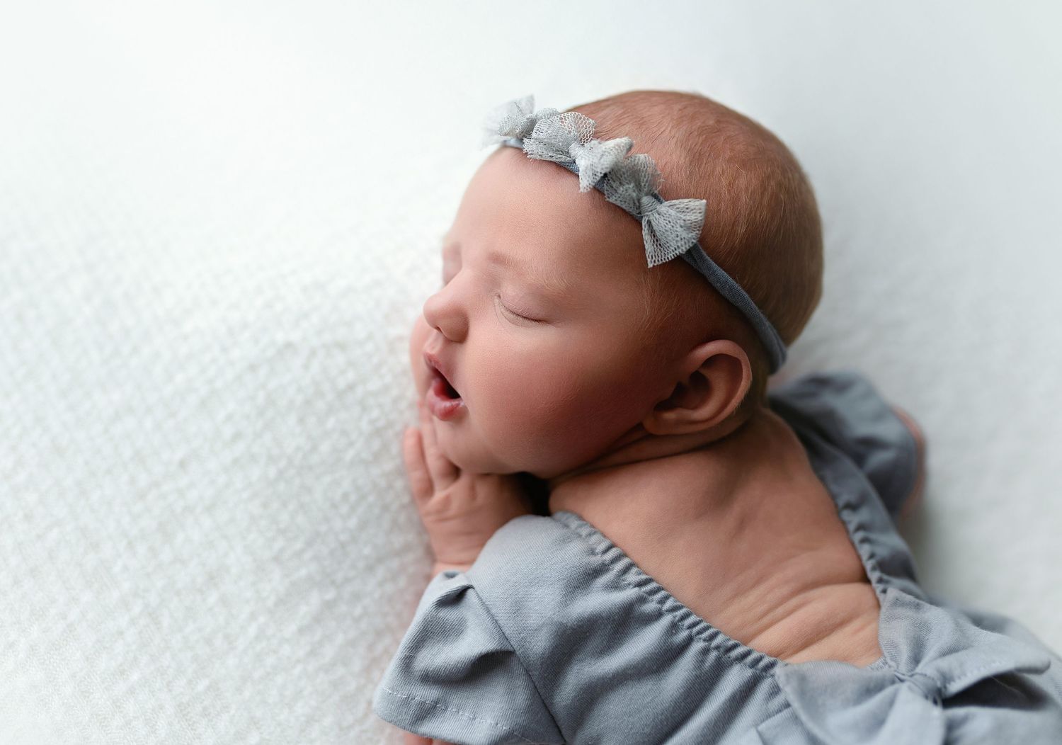 A profile shot of baby girl in a gray outfit. - Greenville SC newborn photographer - Easley SC newborn photographer