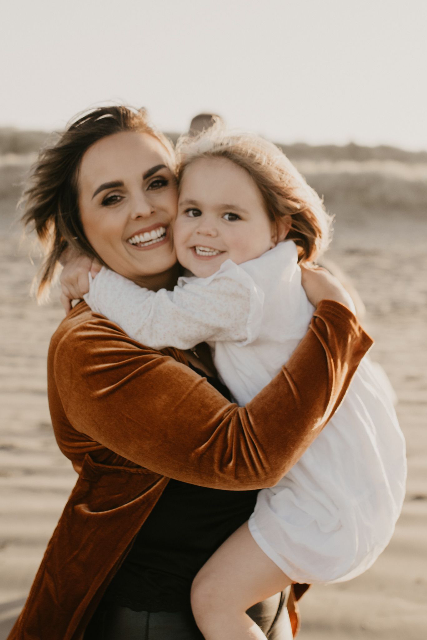 Warm and intimate portrait against neutral desert backdrop during golden hour.