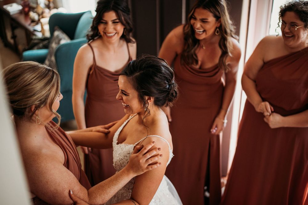 The couple shares an intimate emotional moment in warm indoor lighting during their wedding celebration.