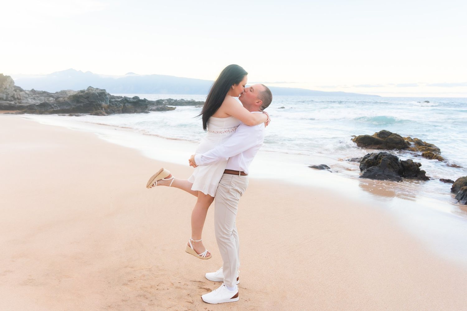 Maui couple engagement photographer photo against beautiful Maui sunset beach cliff by ohwowfotos.