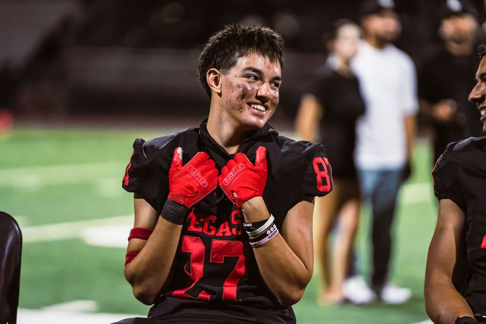Football player sitting and looking off right