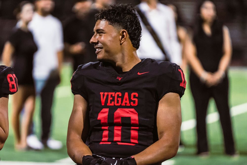 Football player sitting and looking off left