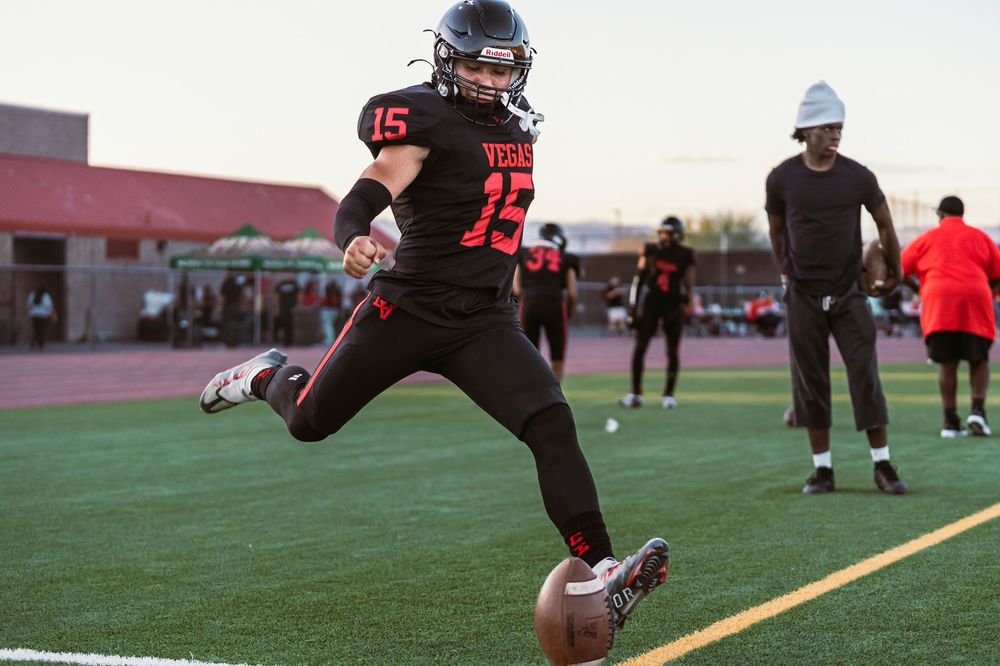 Football player mid kick during pre-game