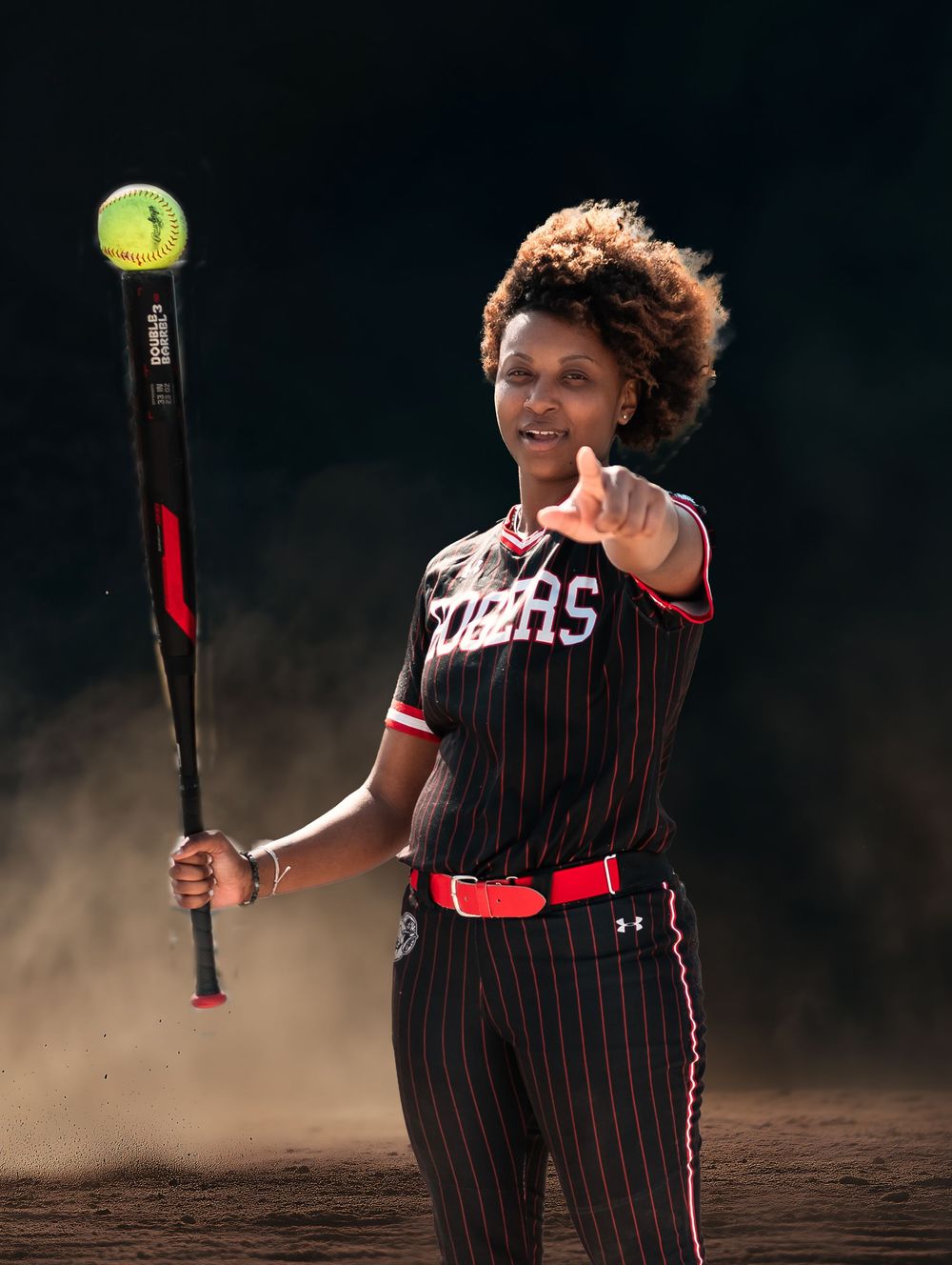 Baseball player in pinstriped uniform swings bat during dramatic action sequence against dark background.