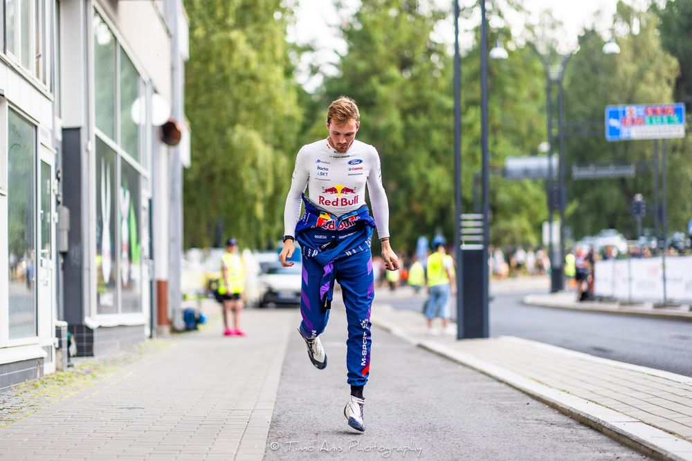 A sequence of images showing a person in athletic gear jogging on a paved path near buildings and trees.