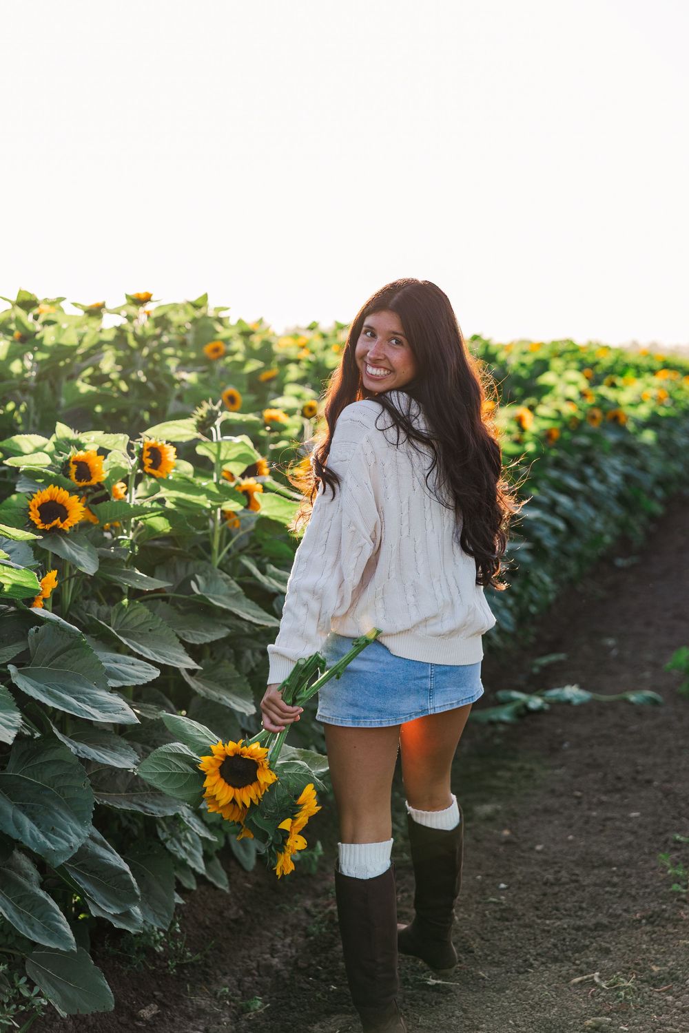 Senior portrait in a golden sunflower field at Conejo Family Farms, Camarillo — timeless, natural, and full of vibrant summer charm.