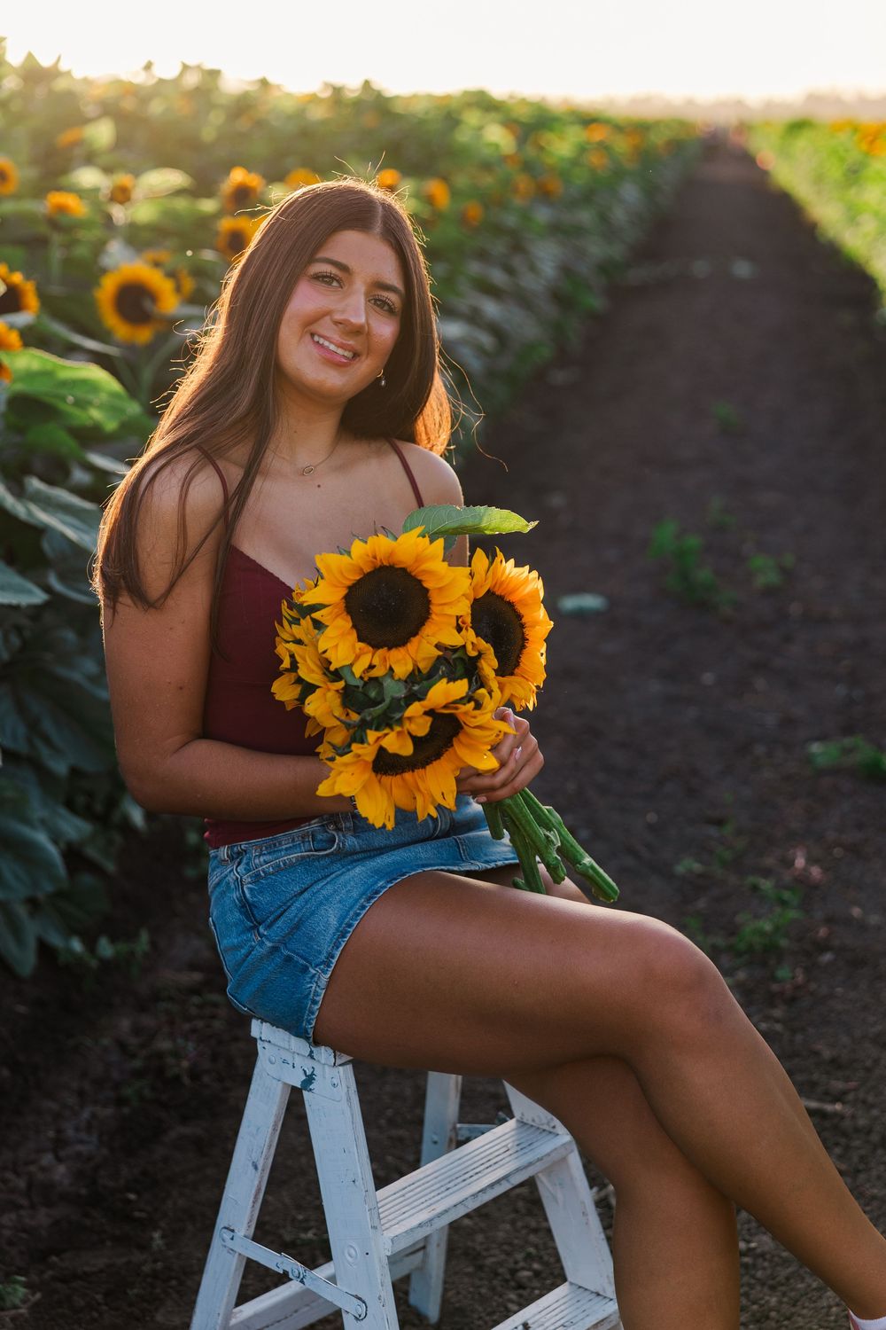 Senior portrait in a golden sunflower field at Conejo Family Farms, Camarillo — timeless, natural, and full of vibrant summer charm.