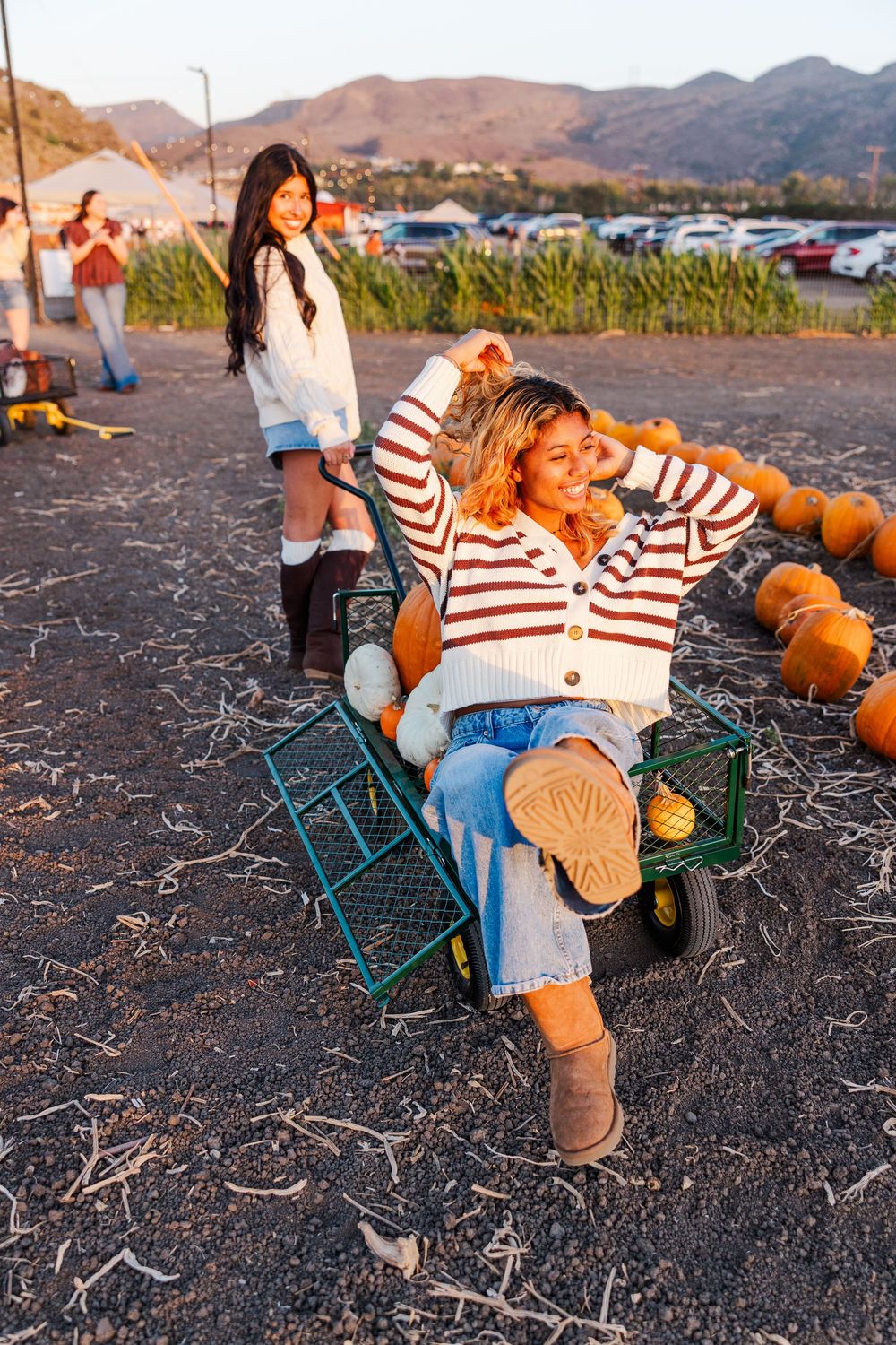Senior photo among pumpkins at Conejo Family Farms, Camarillo — autumn vibes, charming, and ideal for capturing fall spirit.