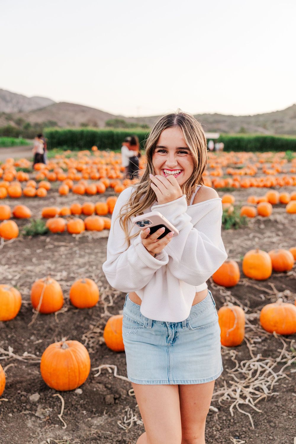 Senior photo among pumpkins at Conejo Family Farms, Camarillo — autumn vibes, charming, and ideal for capturing fall spirit.