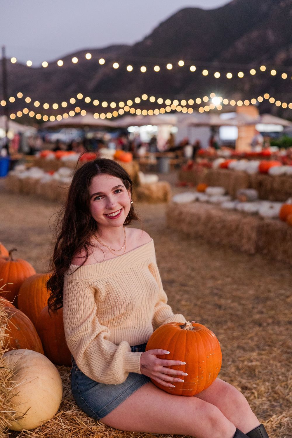 Senior photo among pumpkins at Conejo Family Farms, Camarillo — autumn vibes, charming, and ideal for capturing fall spirit.