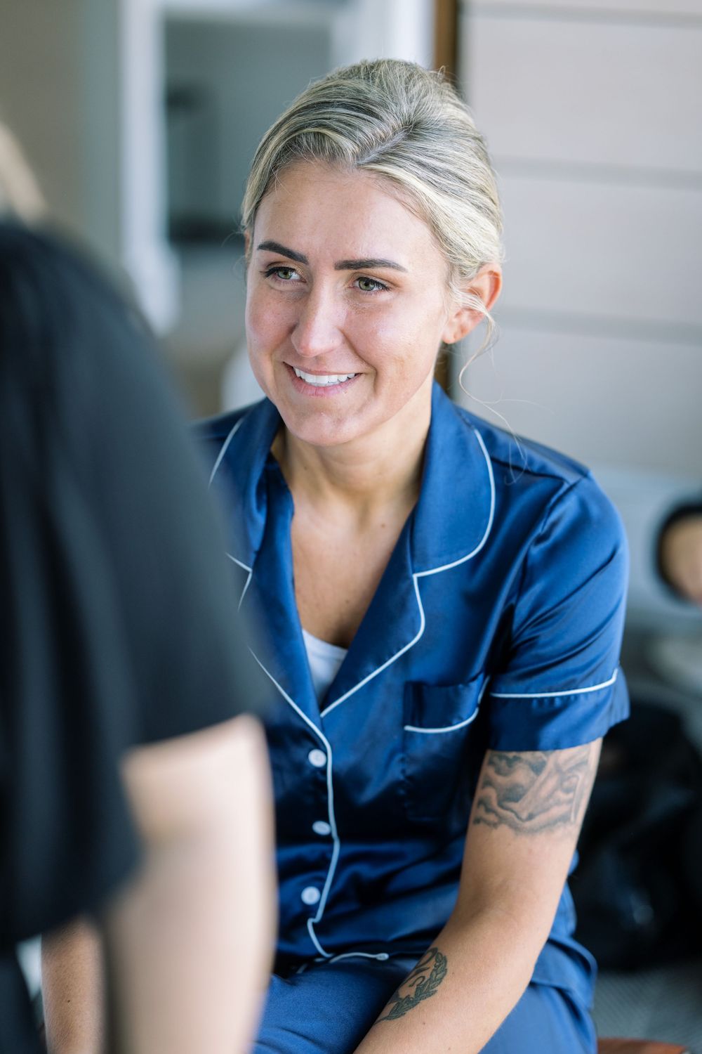 Professional stylist in blue uniform preparing for a special event.
