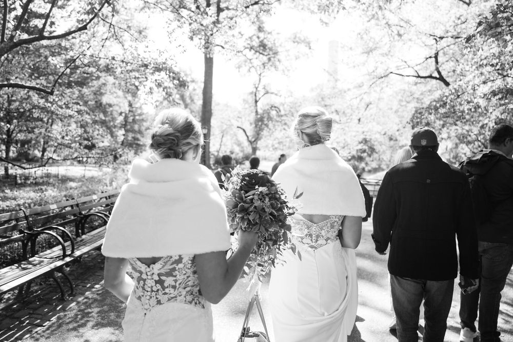 Wedding party walking together outdoors in black and white photography.