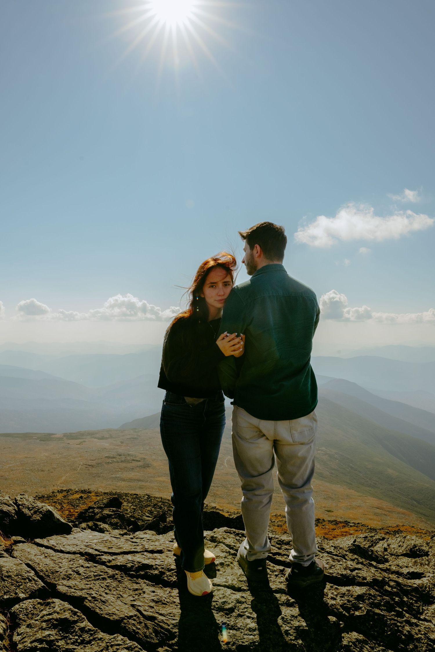 Memory Lane Studios romantic engagement session on Mt Washington rocky mountain terrain under bright sunlight by Tharun Palla