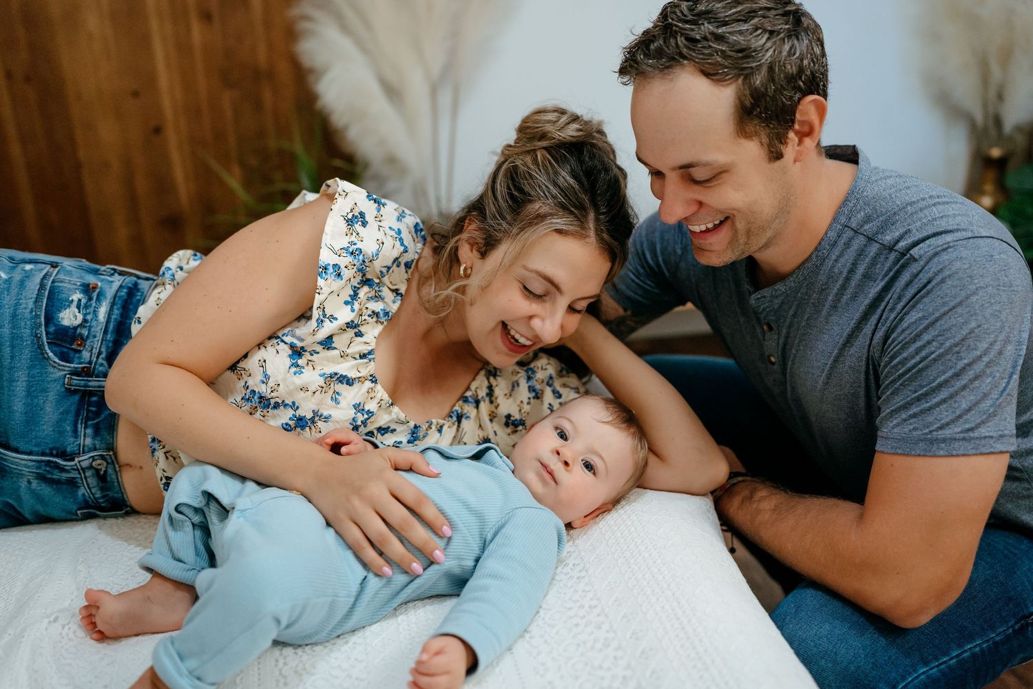 A series of intimate family moments captured in a sequence of photos showing cuddling and bonding on a bed.