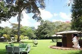 luxury garden wedding venue in Nairobi, captured by Nairobi Wedding Photographer, Bonnie Gichuru, showcasing lush greenery and flower arches