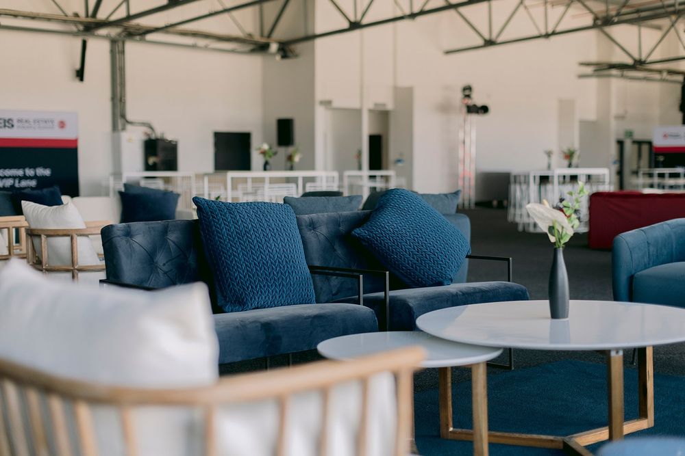 Modern blue and white lounge seating area set up for a corporate event.